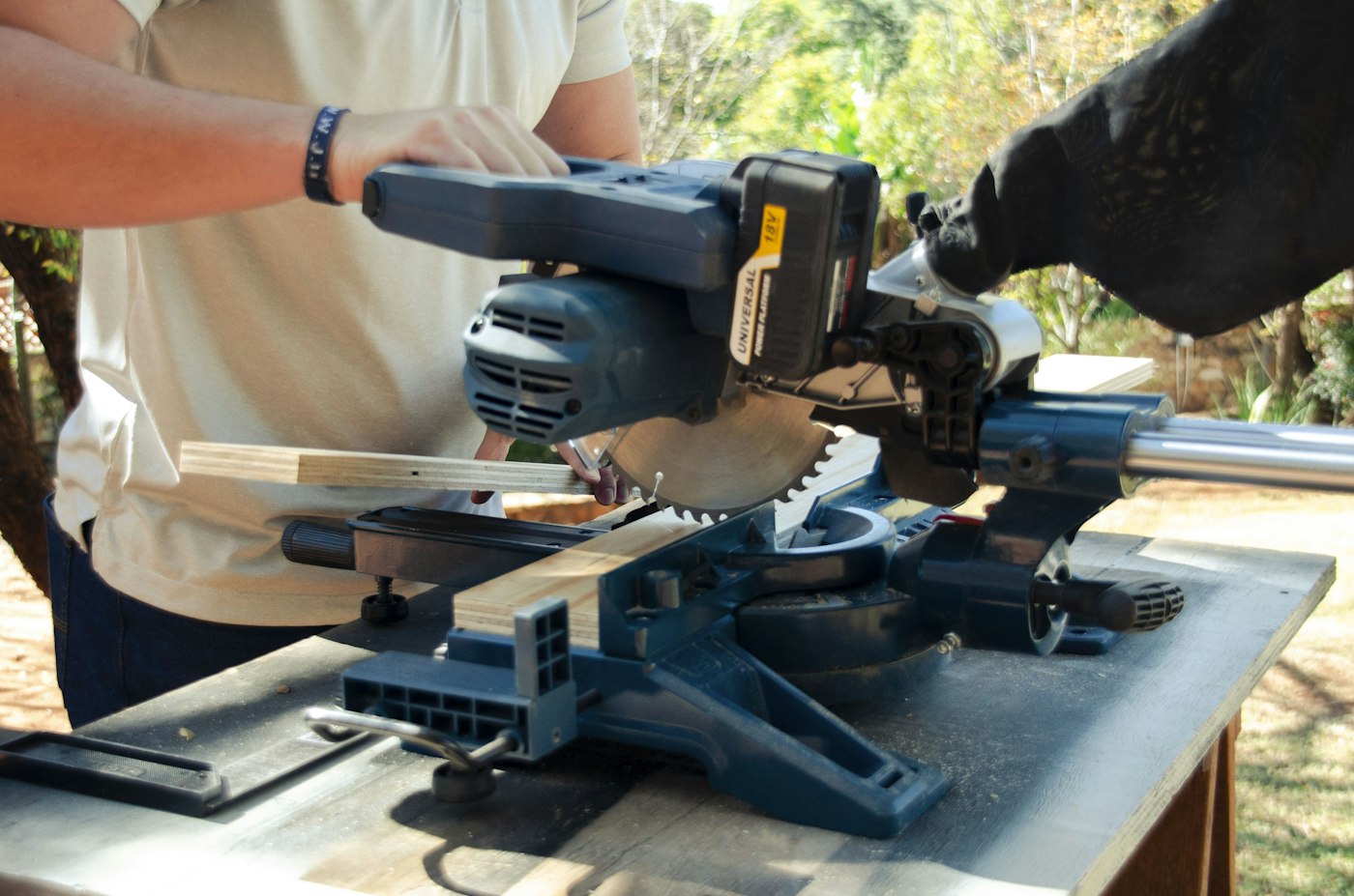 A mitre saw cutting a length of timber